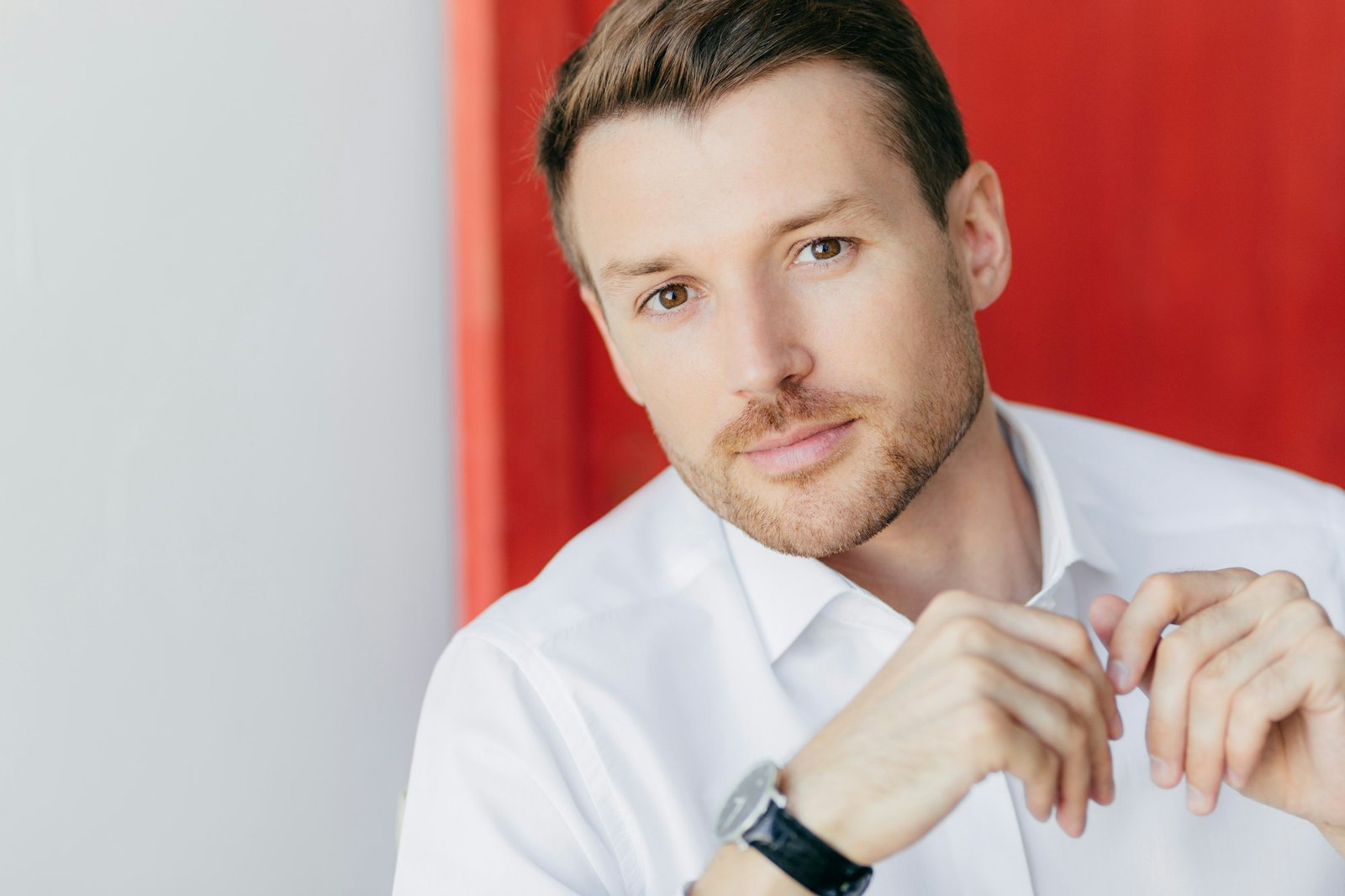 Image of thoughtful self confident male entrepreneur in white shirt
